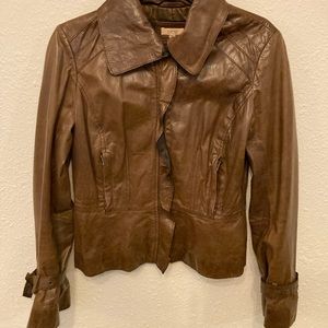 Brown leather jacket by Cache, size 2, slights worn.